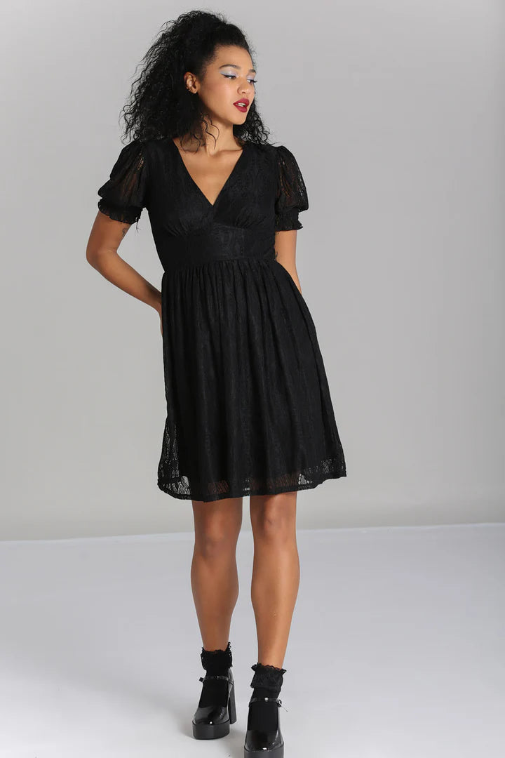A model wearing a black lace mini dress with short puff sleeves, a V-neck chestline, and a flared skirt.